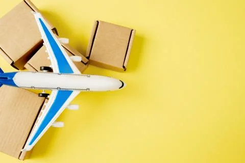 Airplane and stack of cardboard boxes. concept of air cargo and parcels, airm Stockfoto's