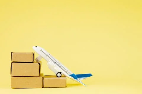 Airplane and stack of cardboard boxes. concept of air cargo and parcels, airm Stock Photos
