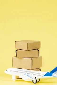 Airplane and stack of cardboard boxes. concept of air cargo and parcels, airm Stock Photos