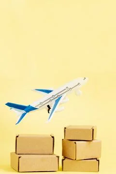 Airplane and stack of cardboard boxes. concept of air cargo and parcels, airm Stock Photos