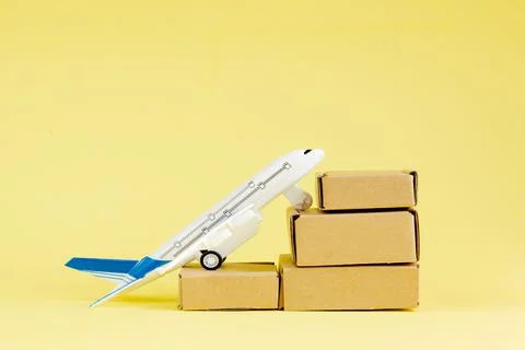 Airplane and stack of cardboard boxes. concept of air cargo and parcels, airm Stock Photos