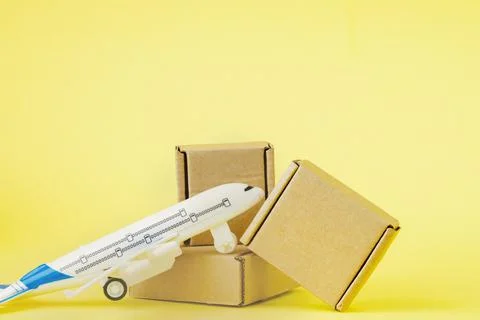 Airplane and stack of cardboard boxes. concept of air cargo and parcels, airm Stockfoto's