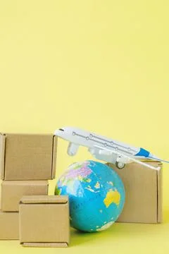 Airplane and stack of cardboard boxes. concept of air cargo and parcels, airm Stock Photos