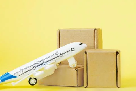 Airplane and stack of cardboard boxes. concept of air cargo and parcels, airm Stock Photos