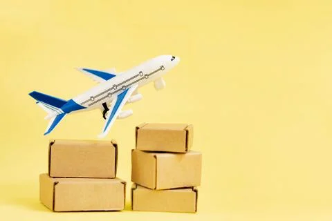 Airplane and stack of cardboard boxes. concept of air cargo and parcels, airm Stock Photos