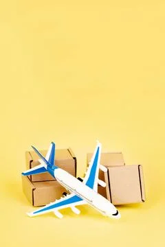 Airplane and stack of cardboard boxes. concept of air cargo and parcels, airm Stock Photos