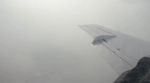 Airplane approaching airport in cloudy day Stock Footage