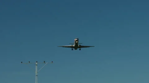 An airplane approaching in super slow motion against a blue sky Stock Footage 61627463