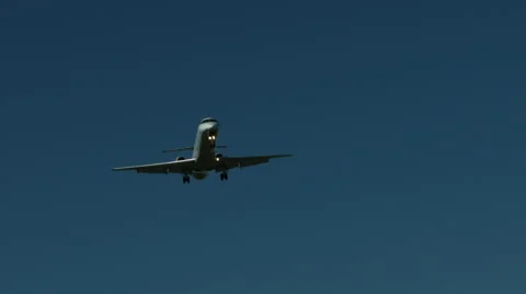 An airplane approaching in super slow motion against a blue sky Stock Footage 61627467