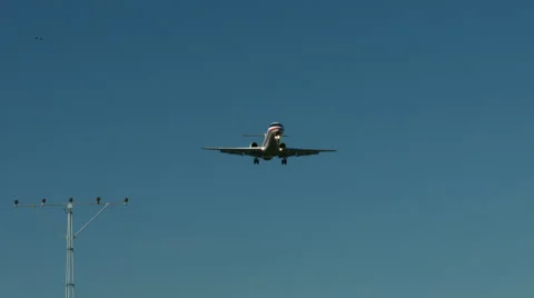 An airplane approaching in super slow motion against a blue sky Stock Footage 61627477