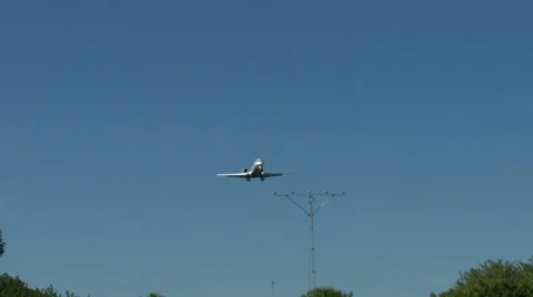An airplane approaching in super slow motion against a blue sky Stock Footage 61649009