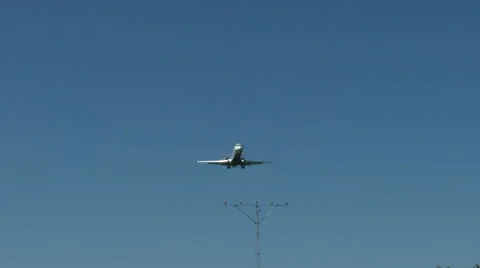 An airplane approaching in super slow motion against a blue sky Stock Footage 61649027