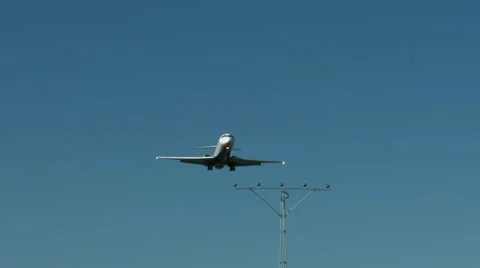 An airplane approaching in super slow motion against a blue sky Stock Footage 61649033