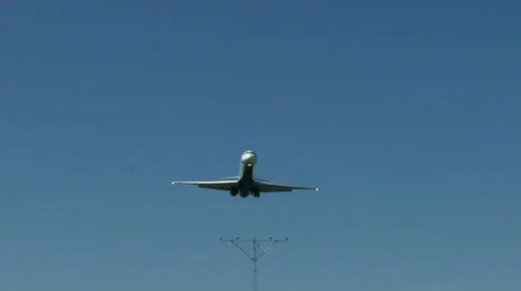 An airplane approaching in super slow motion against a blue sky Stock Footage 61649039