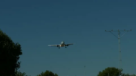 An airplane approaching in super slow motion against a blue sky Stock Footage 61649040
