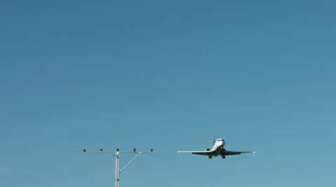 An airplane approaching in super slow motion against a blue sky Stock Footage 61649048