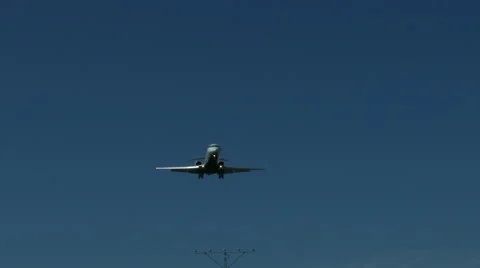 An airplane approaching in super slow motion against a blue sky Stock Footage 61649053
