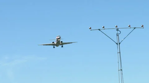 An airplane approaching in super slow motion against a blue sky Stock Footage 61649067