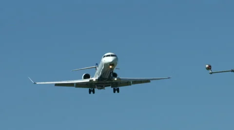 An airplane approaching in super slow motion against a blue sky Stock Footage 61649071