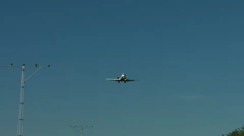 An airplane approaching in super slow motion against a blue sky Stock Footage 61649085