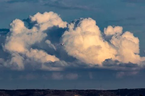 An airplane with a background of clouds Stock Photos