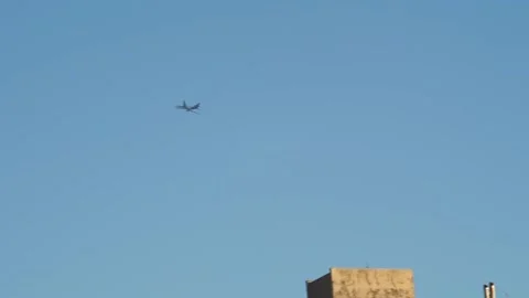 Airplane banking right in sky during golden hour Stockbeeldmateriaal 233902841