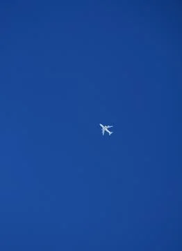 An airplane with a blue sky in the background Stock Photos