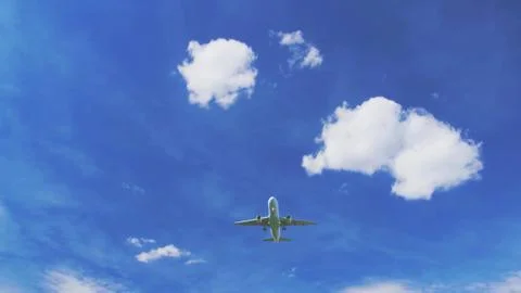 Airplane in blue sky with clouds. Stock Photos
