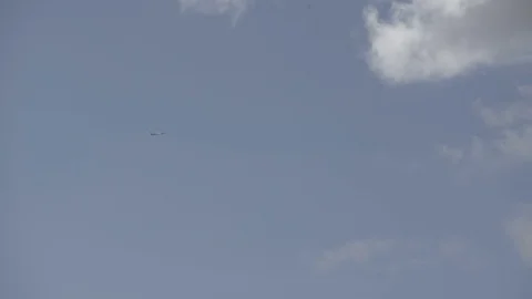 Airplane on blue sky going into clouds Stock Footage 71211516