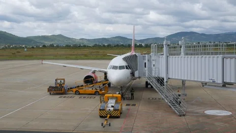 Airplane boarding and loading cargo containers. DALAT, VIETNAM - DECEMBER 01 Stock Footage 122328600