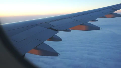 Airplane Boeing passenger flight over sea clouds during sunset, travel Stock Footage 235141790