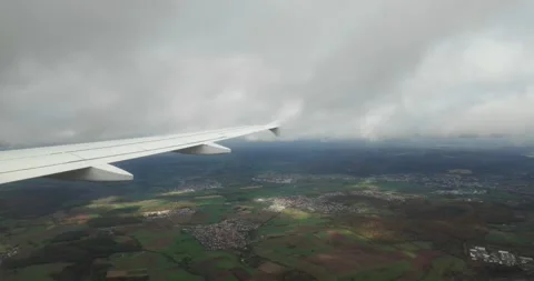 Airplane breaking through thick cloud layer during descent Stock Footage 320289051