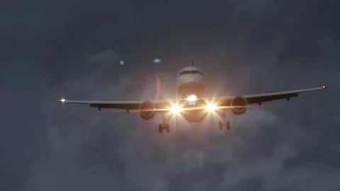 Airplane with bright lights approaching Stock Footage 71060055