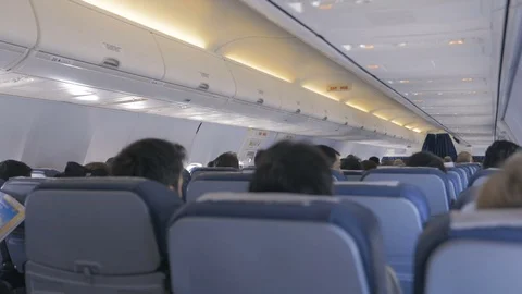 Airplane cabin full of passengers Stock Footage 74095257