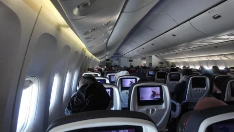 Airplane Cabin Interior with Passengers and Seatback Screens Video stock 327764205