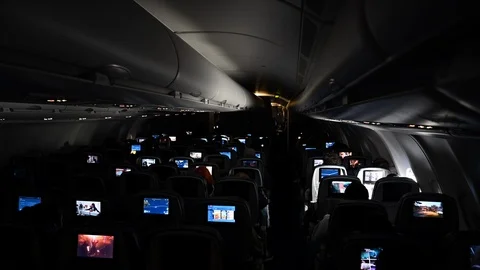 Airplane cabin with passengers using multimedia devices during a turbulence Stock Footage 126245558