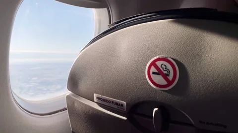 Airplane Cabin Window View With No Smoking Sign And Passenger Seat Interior Video stock 328713604