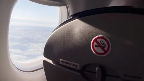 Airplane Cabin Window View With No Smoking Sign On Seat Back In Flight Interior Stock Footage 328714487