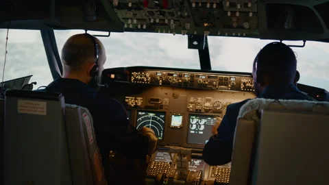 Airplane captain and copilot looking at ... | Stock Video | Pond5