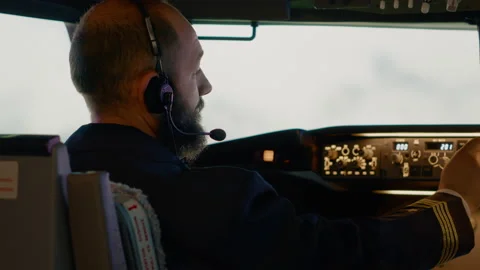 Airplane captain pushing buttons to fix altitude and longitude Stock Footage 211284339