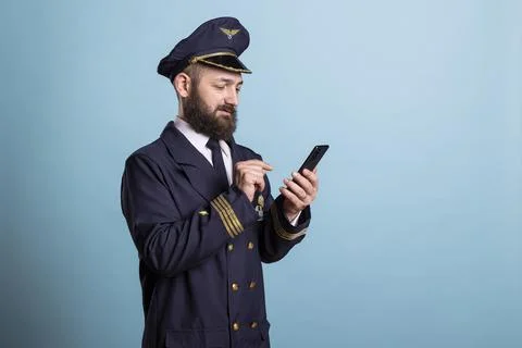 Airplane captain typing on smartphone touchscreen display Stock Photos