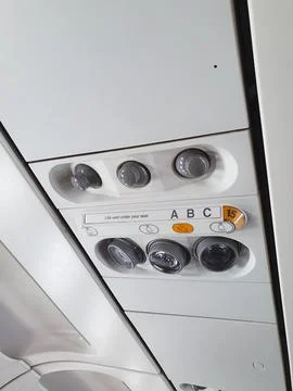 Airplane ceiling panel with air conditioning vents and reading lights Foto stock
