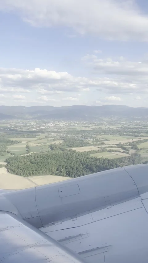 Airplane Climbing after Takeoff – View of Farmland and Mountains Stock Footage 310047325