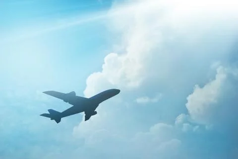 Airplane in the cloud sky on sunset Fotos Stock