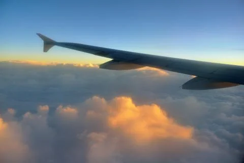 Airplane in clouds Stock Photos