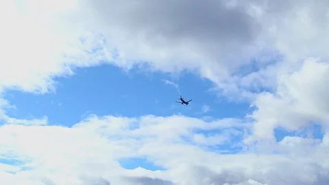 Airplane in the cloudy sky Stock Footage 126778475
