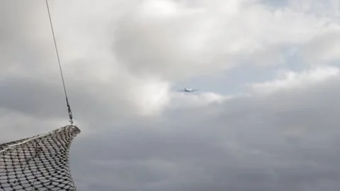 Airplane in a cloudy sky Stock Footage 342775691