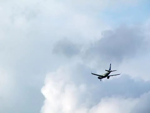 Airplane on cloudy sky Stock Photos