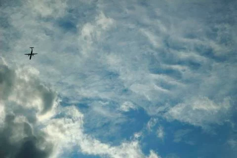 Airplane in a cloudy sky  Stock Photos
