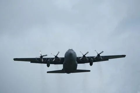 Airplane in the cloudy sky. Stock Photos
